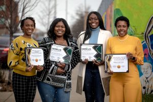 Women holding certificates of recognition from Catapult Startup to Storefront program