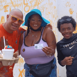 Darnella Murray proudly holding up her business card