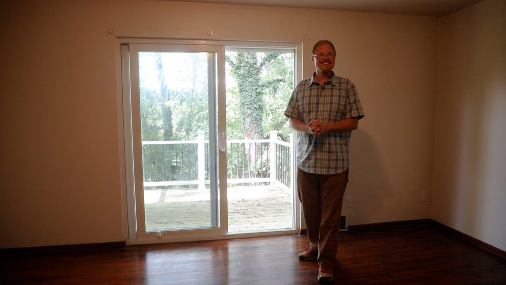 Kendall Pulling proudly standing in a repaired home