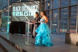 Tammy Thompson and Mary Hester on stage presenting at the 2024 BERE Gala