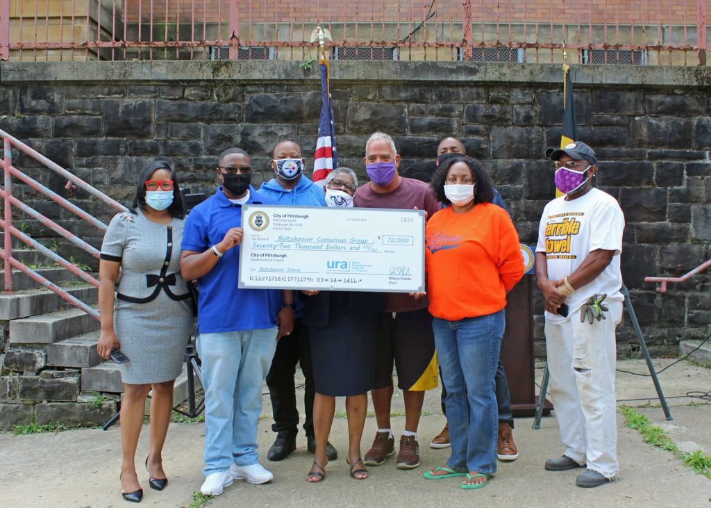 Beltzhoover Consensus Group holding a check