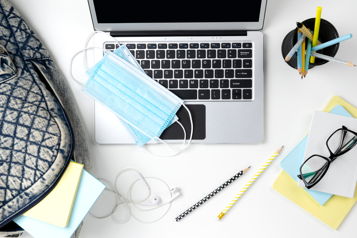 laptop with surgical mask on keyboard