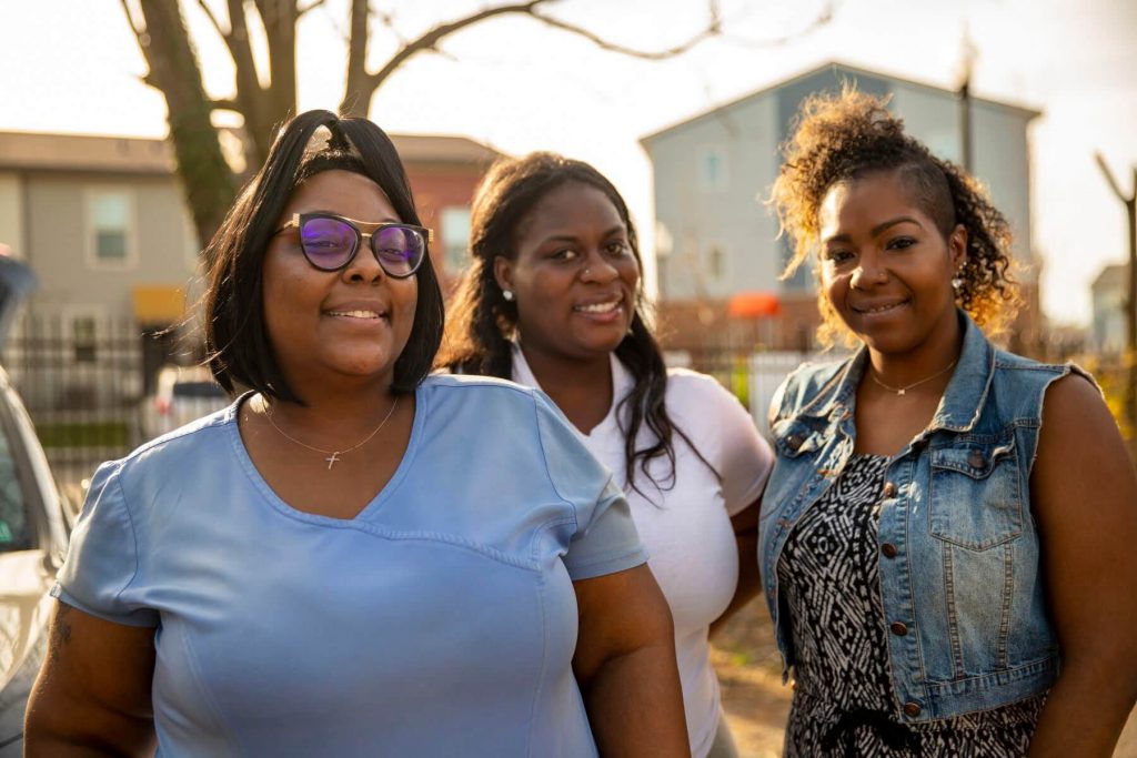 Jasmine Devine of East Liberty's Enright Court (left). Brettney Duck of Catapult Greater Pittsburgh and Mary Hester of LifeVenture Real Estate Services have worked together to get Devine lined up to buy a townhouse for herself and three daughters. (Photo by Jay Manning/PublicSource) (Photo by Jay Manning/PublicSource)