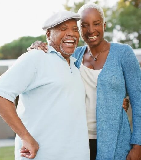 older couple standing outside and laughing