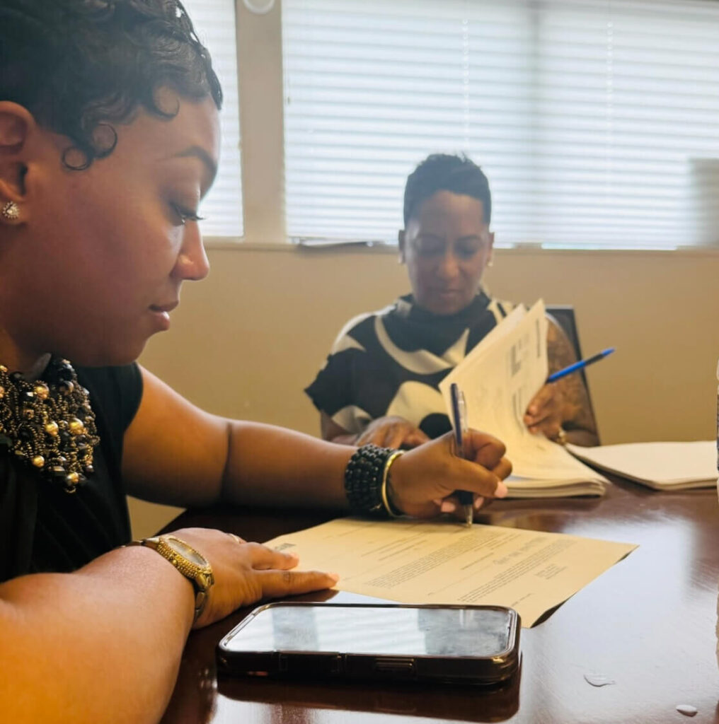 Kecia signing documents